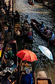 Thailand, Locals sell fruits, food and products at Damnoen Saduak floating market near Bangkok 